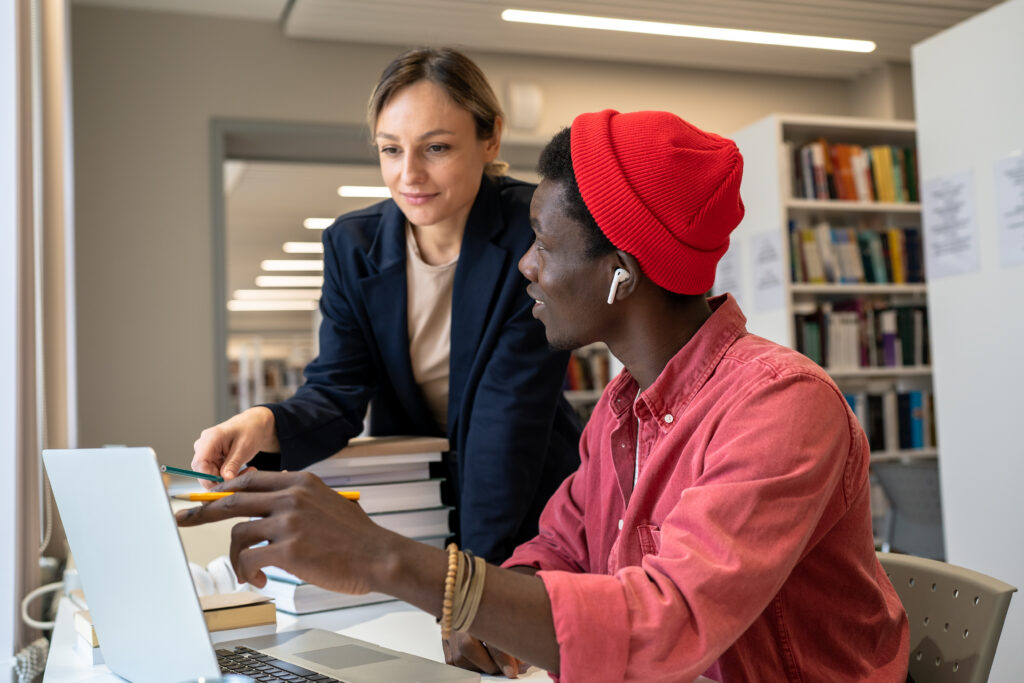 A seasoned professional guiding a young employee through mentorship